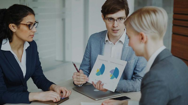 A sales team reviewing charts together